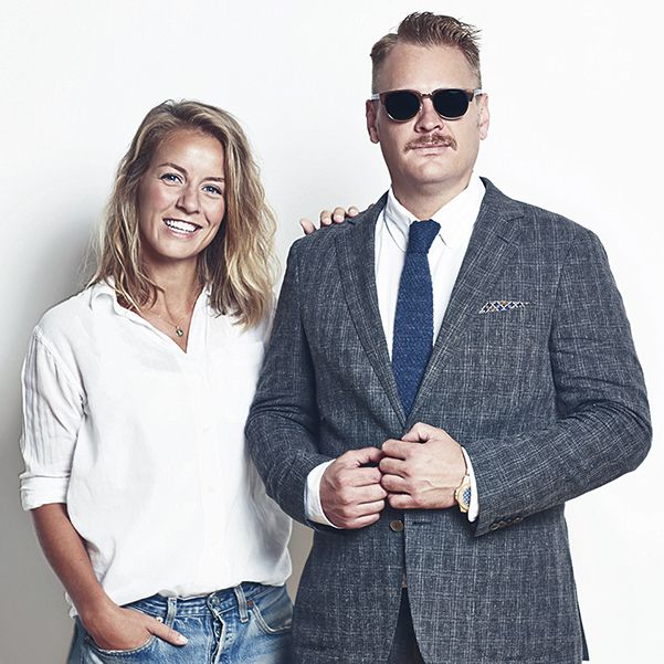 Photo of smartly dressed man posing next to a casually dressed woman